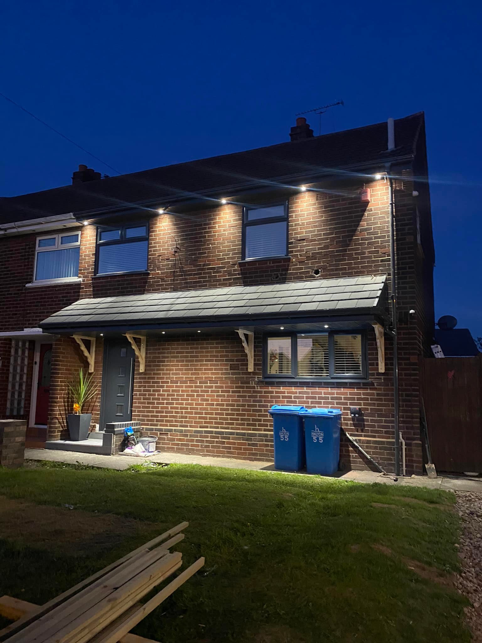 Newly installed roof on a houes lit up at night