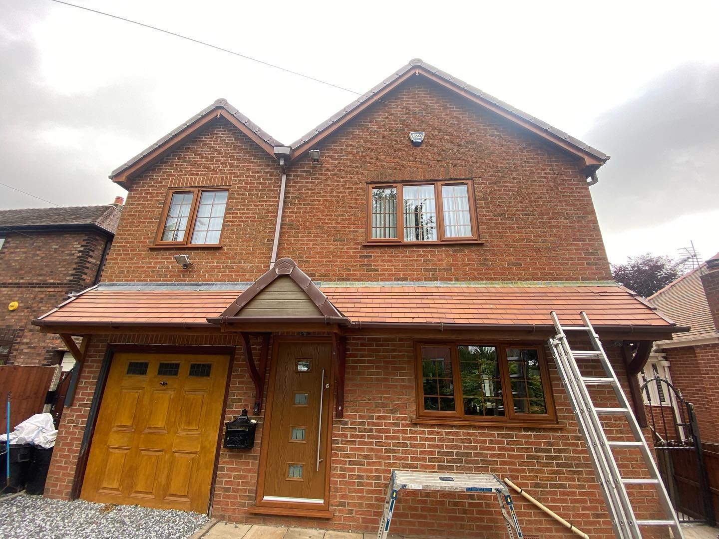 Brick house with garage and old roof