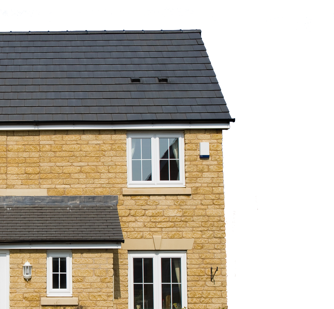 Brick house with white windows and a black roof